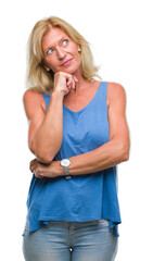 Sticker - Middle age blonde woman over isolated background with hand on chin thinking about question, pensive expression. Smiling with thoughtful face. Doubt concept.