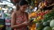 © Good moose - Market scene featuring a woman engaging with her phone surrounded by fresh fruits and vegetables. The vibrant assortment includes colorful produce like tomatoes and oranges.