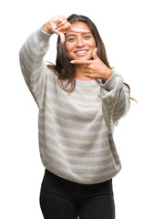 Poster - Young beautiful arab woman wearing winter sweater over isolated background smiling making frame with hands and fingers with happy face. Creativity and photography concept.