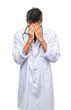 © Krakenimages.com - Adult hispanic doctor man over isolated background with sad expression covering face with hands while crying. Depression concept.