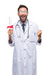 © Krakenimages.com - Adult hispanic doctor man holding degree over isolated background screaming proud and celebrating victory and success very excited, cheering emotion