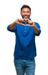 © Krakenimages.com - Adult hispanic man over isolated background smiling in love showing heart symbol and shape with hands. Romantic concept.