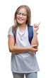 © Krakenimages.com - Young beautiful smart student girl wearing backpack over isolated background with a big smile on face, pointing with hand and finger to the side looking at the camera.