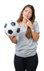 Sticker - Young beautiful brunette woman holding soccer football ball over isolated background serious face thinking about question, very confused idea