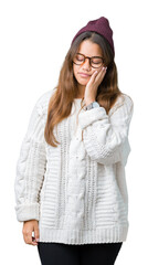 Wall Mural - Young beautiful brunette hipster woman wearing glasses and winter hat over isolated background thinking looking tired and bored with depression problems with crossed arms.