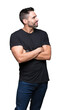 © Krakenimages.com - Young handsome man over isolated background smiling looking to the side with arms crossed convinced and confident