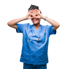 Wall Mural - Young braided hair african american girl professional surgeon over isolated background doing ok gesture like binoculars sticking tongue out, eyes looking through fingers. Crazy expression.