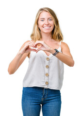 Wall Mural - Beautiful young woman over isolated background smiling in love showing heart symbol and shape with hands. Romantic concept.