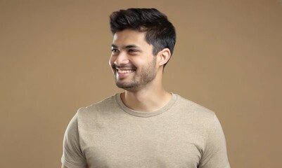 Wall Mural - Portrait of a handsome young man smiling against a brown background.