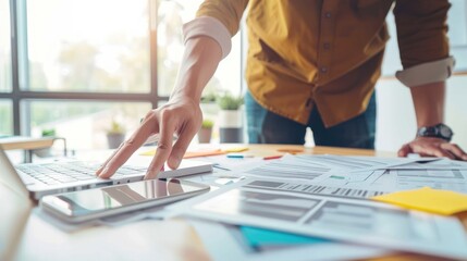 Poster - Businessman working on laptop and smartphone with documents on desk