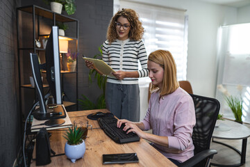 Two Women Working on a Computer in an Office