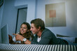 © Sanc/peopleimages.com - Point, couple and relax with laptop in bedroom for streaming entertainment, movies and subscription channel. Man, woman and together in home with internet for online download, multimedia and bonding.