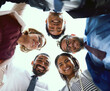 © peopleimages.com - Business people, group and low angle for portrait, huddle or happy with hug, solidarity and diversity. Team, scrum or circle with support, connection or link for synergy in office at insurance agency