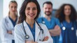 © jodoto - Female Doctor with Medical Team in Discussion - A friendly female doctor smiles confidently while engaging in a discussion with her medical team, showcasing a collaborative healthcare environment.