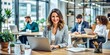 © Sirinporn - Smiling professional female entrepreneur stands confidently in modern office, surrounded by laptops and papers, exuding positivity and productivity in a bustling work environment.