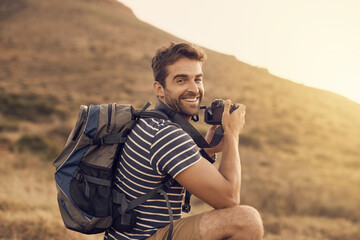 Canvas Print - Happy man, hiking and portrait in exploration, photography and nature for travel, adventure or vacation. Male person, camera and countryside for discovery, journey and mountain for outdoor recreation