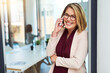 © SensSai/peopleimages.com - Company, phone call and woman with smile in office for business, planning or communication. Real estate agent, happy and consulting with technology for property lease, negotiation or update to client