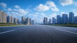 © liliyabatyrova - A broad asphalt road stretches ahead, flanked by tall buildings under a vibrant blue sky with fluffy clouds, creating a dynamic urban atmosphere