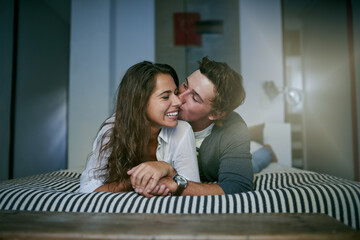 Poster - Happy couple, bedroom and kiss with relax, comfort and rest in home on weekend as romantic partner. People, love and affection for wake up, care or intimacy in apartment or house for bonding together