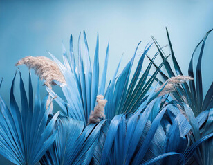 Tropical surreal background with blue grass and reed arundo donax against blue sky