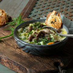 Wall Mural - bowl of soup with potatoes and butter on the table, top view