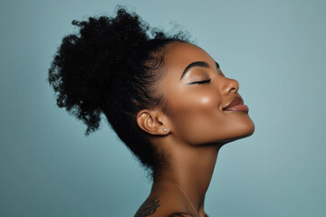 A close up of a tattooed black woman's face with her eyes closed