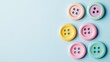 © Murda - Pastel buttons arranged on blue background.