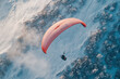 © Chin - Paragliding on the snow forest with tiny bush, Aerial view paraglider with parachute on the top of snow mountain.