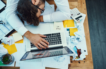 Business man, sleeping and documents in office, above and exhausted with laptop at insurance agency. Person, computer and fatigue with burnout at job, chaos and sales graphs for audit at company