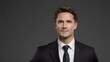 © Royal studio - man in a black suit and white shirt, standing confidently against a grey background, perfect for corporate branding or formal portraits