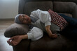 © Hendra Fauzy - Asian Woman With Veil Sleeping At Home On Couch, Feeling Exhausted After Work