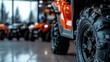 © JoxyAimages - A row of quad bikes on display in an indoor showroom, focusing on the foremost vehicle, presenting a sense of readiness, adventure, and high energy in a commercial environment.