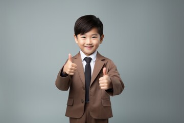 Poster - Hongkonger little boy doing thumbs up portrait smile photo.