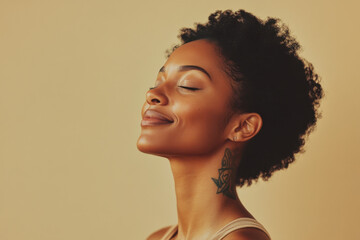 A close up of a tattooed black woman's face with her eyes closed