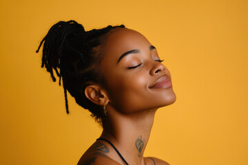 A close up of a tattooed black woman's face with her eyes closed