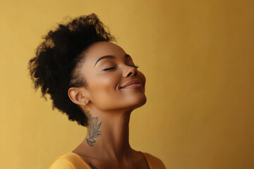 A close up of a tattooed black woman's face with her eyes closed