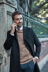 Wall Mural - Business, man and outdoor in phone call with smile for conversation and connection in New York as lawyer. Male person, employee and happiness in street with communication, networking and legal advice