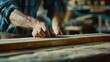 © pinkrabbit - man owner a small furniture business is preparing wood for production. carpenter male is adjust wood to the desired size. architect, designer, Built-in, professional wood, craftsman, workshop.