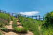 © Kalina - Wooden fence in the mountains. Placed to protect tourists from accidental falls. Rila mountain, Bulgaria. Clear blue sky with gentle clouds.