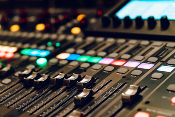 Wall Mural - control panel with colorful lights during a live sound mixing session. a detailed view of a sound mi