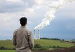 © Zafercan - A person stands before an industrial landscape emitting pollution, symbolizing environmental impact and the need for sustainable practices.