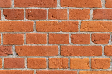 Close-up of a red brick wall. rough, aged bricks. Background and texture