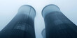 © HelgaQ - Futuristic Cooling Towers in Misty Industrial Landscape