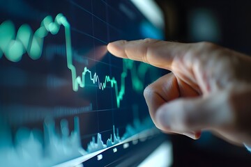 Businessman pointing at a graph with an upward line on a virtual screen.