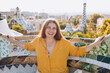 © mdyn - Woman 30s tourist having fun visiting famous Guell park in Barcelona. Concept of travel, tourism and vacation in city. High quality photo