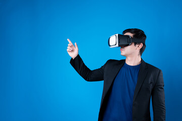 Wall Mural - Profile businessman wearing VR headset looking to connect metaverse pointing to choose interesting data isolated blue background futuristic analytics communication tech virtual reality. Contrivance.