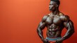© Светлана Гуркова - Muscular bodybuilder poses in front of an orange backdrop showcasing his physique