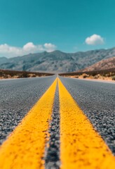 Wall Mural - Empty road stretching into the mountains under a clear sky