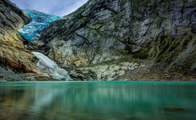 Panoramic view of the Briksdalsbreen glacier with Briksdalsvatn meltwater lake in the foreground