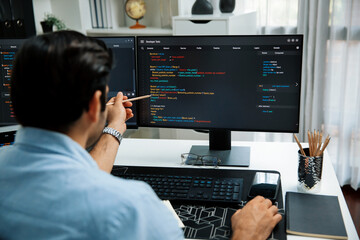 Smart IT developer pointing data software development lines on pc, creating application program update version online website page system showing to target customer, working at modern office. Surmise.